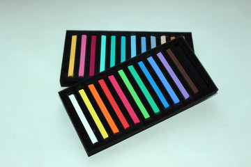 Chalks in a variety of colors arranged on a white background