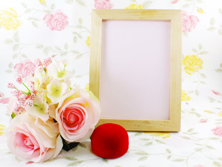 wood frame ande pink roses with red velvet box on sweet background