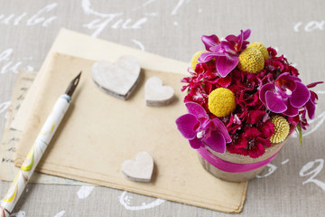 Floral arrangement with orchid and craspedia flowers