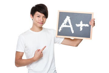 Man hold with chalkboard showing A plus mark