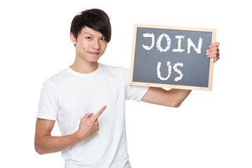 Man hold with chalkboard showing a phrases of join us