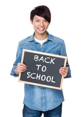 Asian young man with chalkboard showing phrases of back to schoo