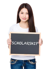 Asian young woman hold with chalkboard showing a word of scholar