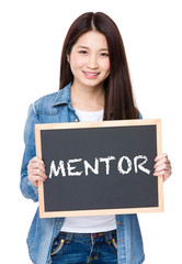 Young woman hold with chalkboard showing a word of mentor