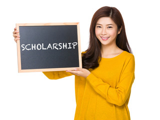 Young woman hand hold with the blackboard showing a word of scho