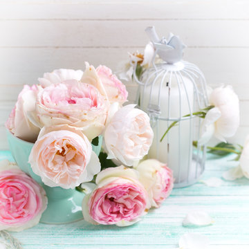 Background with sweet pink roses in vase and candle