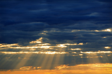 Obraz na płótnie Canvas Rays of light shining through dark clouds for background
