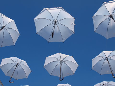 White umbrelas over blue sky