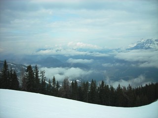 Panoramic view on the snowy winter landscape in the mountains, in the Austrian ski resort Schladming, on a foggy cloudy day.