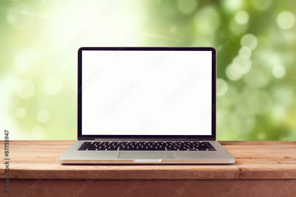 Wall mural laptop computer mock up over nature bokeh background. retro filter effect