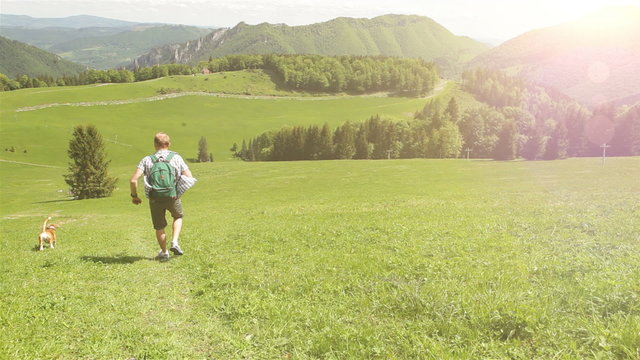 Man's on a mountain walk with his four-legged friend
