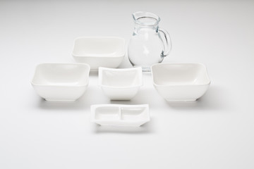 porcelan dishes and glassware pitcher white background