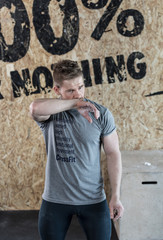 Naklejka na ściany i meble Man training in a garage