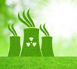 Green nuclear power plant icon on meadow 
