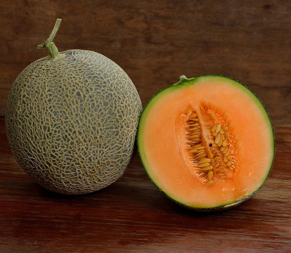 Fresh melon on wooden background.