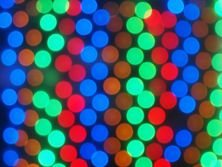 Defocused and blurry image of multicolored lights