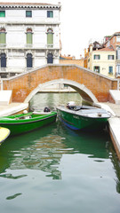 bridge and boats in canal Venice