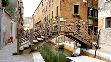 wooden bridge and boats in canal