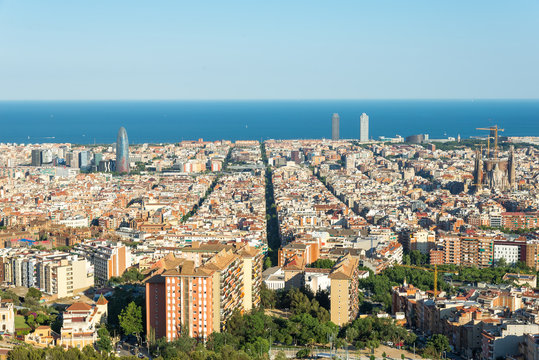 The Torre Agbar in the Barcelona district Poblenou. The Sagrada Familia in the district Eixample. In the middle, in the background, the towers of the Port Olimpic