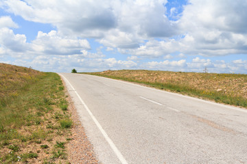 The asphalt  road running diagonally over the horizon