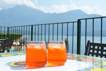 Traditional Italian Spritz cocktail against lake Como, Italy