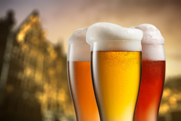 Glasses of beer against blurred european city
