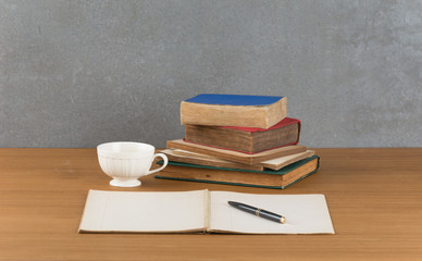 old book with pen on wood table
