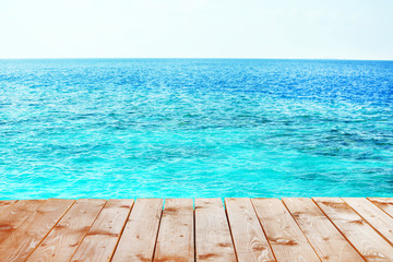 Fototapeta na wymiar Wooden pier with blue sea background