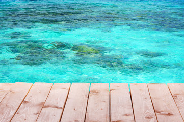 Fototapeta na wymiar Wooden pier with blue sea background