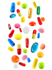 Falling colorful medical pills isolated on white