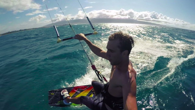 Kiteboarder Riding Fast Over the Water on a Sunny Day in Hawaii. POV Extreme Sports.