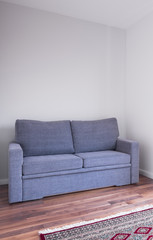 Grey couch on wooden floor