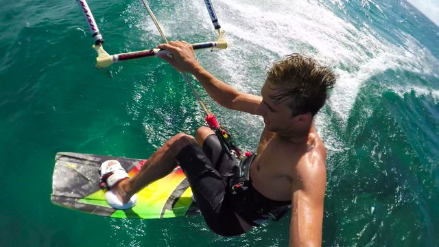 Young Man Kitesurfing Catches Air. Slow Motion HD POV Shot.