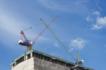 Construction site with cranes on sky background