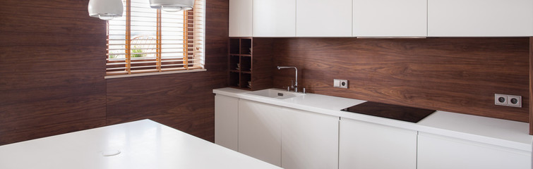 Wooden walls in white kitchen
