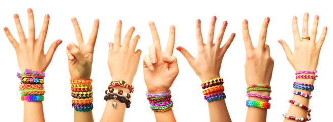 Female hands with bracelets isolated on white - obrazy, fototapety, plakaty