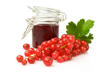 Bunch of red currant and glass jar with jam