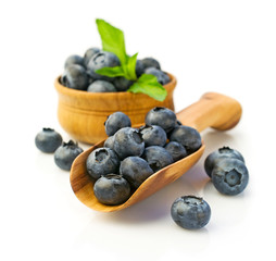 Ripe blueberries in wooden scoop