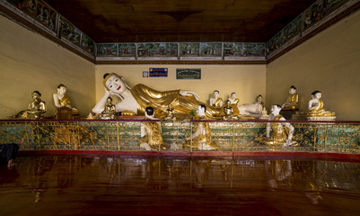 lying Buddha and 10 small monks around the pagoda SWE DAGON