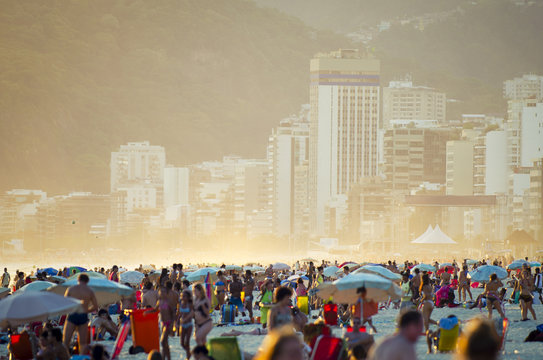 Busy crowded afternoon on Ipanema Beach during a misty sunrise in Rio de Janeiro Brazil
