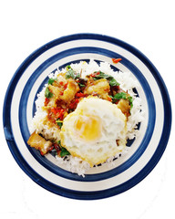 crispy pork fried with basil and egg on the rice, white background