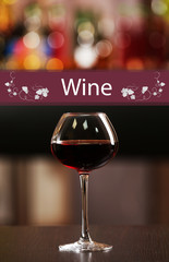 Glass of red wine in bar on blurred background