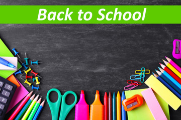 School supplies on blackboard background