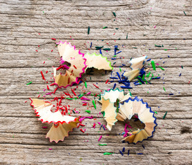 Pencil shavings on wood background