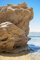 Golden rock in the seashore with clear blue sky seen from the ri