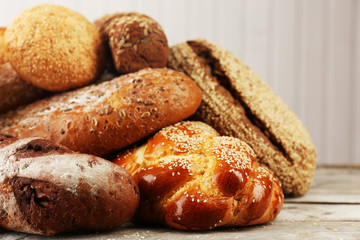 Different bread on wooden background