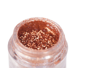 Opened jar with brown bronze shine eye shadows isolated over
