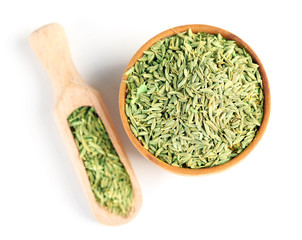 Cumin in wooden bowl, isolated on white