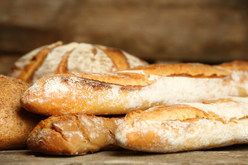 Different fresh bread on old wooden table