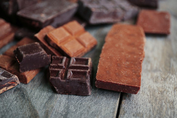 Set of chocolate on wooden table, closeup